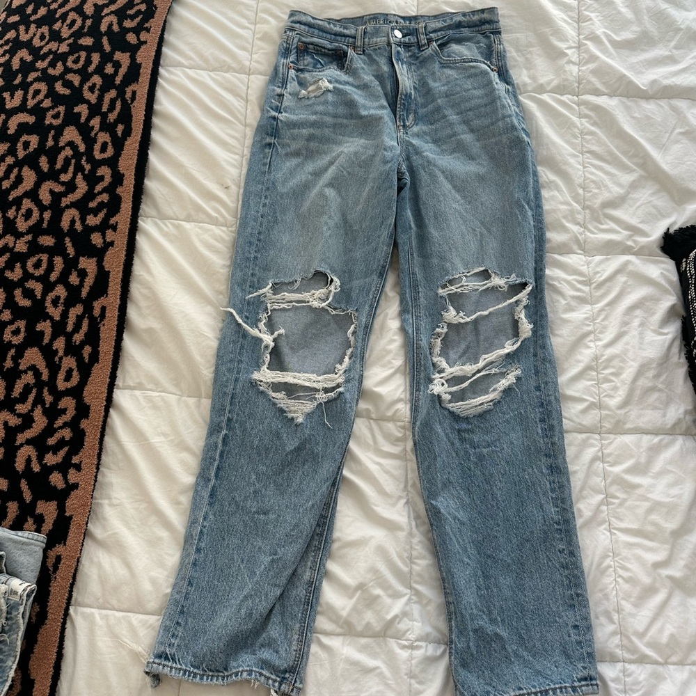 high waisted strigid medium wash with holes jeans